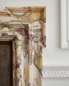 an old fireplace with marbled paint on it