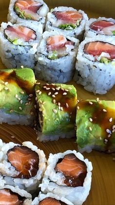 sushi rolls are arranged on a wooden table