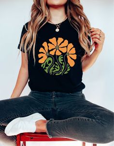 Looking for a groovy flower shirt? Look no further! This retro floral shirt is perfect for any mother's day celebration. The colorful and botanical design is sure to brighten up any outfit. Pair it with some funky sunnies and you're good to go! Our  T-shirts are High Quality, SUPER soft and SUPER comfy. They made of 100% Cotton.  T-Shirt Brands and Model *Unisex T-shirts are Bella Canvas 3001 *Unisex V-Neck Tees are Bella Canvas 3005  *Women Tank Tops are Next Level  *Youth T-Shirts are Bella Ca Funky Tshirts Designs, Hippie Floral Print T-shirt For Summer, Flower Power Shirt, Groovy Short Sleeve T-shirt With Graphic Print, Hippie Cotton T-shirt With Retro Print, Mother's Day Celebration, Groovy Spring Graphic Print T-shirt, Groovy Vibes, Wildflower Shirt