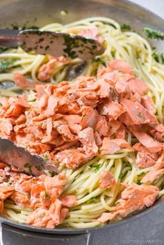 a pan full of pasta with salmon and parsley