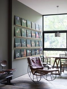 a room with chairs, tables and pictures on the wall