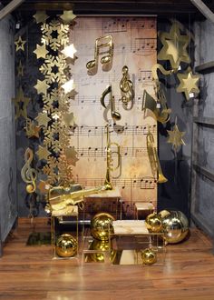 a room filled with lots of musical instruments and gold stars hanging from the ceiling above it