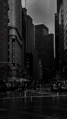 black and white photograph of city street in the rain