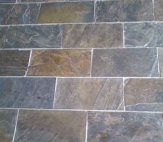 a tile floor that is made out of different types of stones and has been cleaned