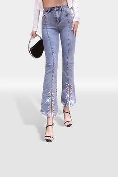 Add some shimmer to your wardrobe with these diamante jeans! Featuring ankle length mom jeans, a high waist profile with a figure-hugging sculpting effect, a split front design, and made of a comfy denim light wash material with crystal rhinestone and pearl embellishment detailing. Team with a scarf top & sandal heels for a sleek & chic weekend look!  Size Measurements (Inch): Waist: 28, 30, 32 Length: 37 Inside Leg: 27 If you are unhappy with any of our products or services, please always conta Trendy Straight Leg Pants With Rhinestones, Trendy Straight Leg Jeans With Rhinestones, Glamorous Straight Leg Denim Bottoms, Trendy Mid-rise Rhinestone Jeans, Fitted High Rise Jeans With Rhinestones, Fitted High-rise Jeans With Rhinestones, Fitted High Rise Rhinestone Jeans, High Waist Pants With Rhinestones, Trendy High Waist Jeans With Rhinestones