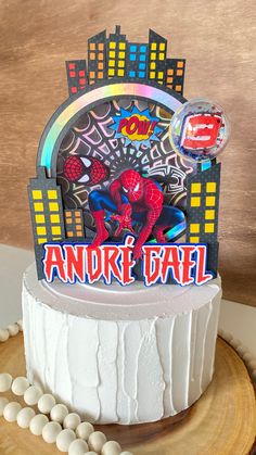 a birthday cake with a spiderman card on top