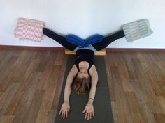 a woman is doing yoga on a mat with her arms stretched out in the air