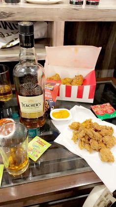 the table is full of food and drinks for two people to eat together, including fried chicken