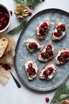 cranberry and goat cheese appetizers on a platter with christmas decorations