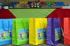 colorful shopping bags are lined up on the table