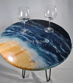 two wine glasses sitting on top of a table with blue and yellow marbled surface