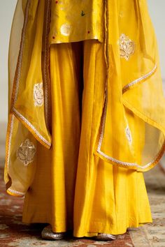 Yellow short kurta with brocade floral jaal detail. Paired with a solid flared palazzo and a hand embroidered dupatta. - Aza Fashions