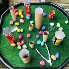 an outdoor play area with plastic cups, scissors and easter eggs