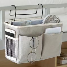 an over - the - bed storage bag with eyeglasses hanging from it