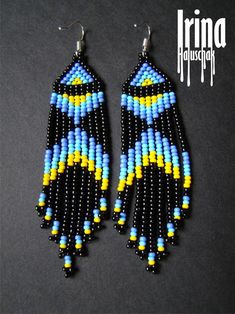 two pairs of beaded earrings with blue, yellow and black beads hanging from them