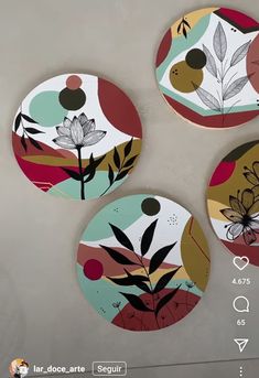 three plates with flowers and leaves painted on them