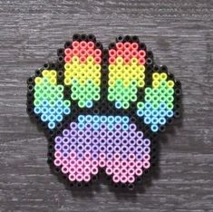 a beaded brooch that has been made to look like a cat's paw