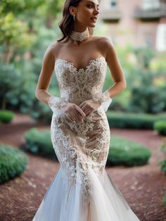 a woman in a wedding dress standing outside