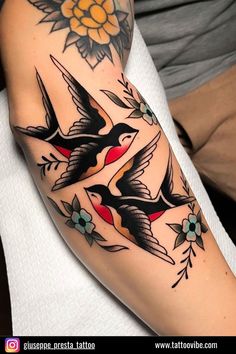 a woman's arm with birds and flowers on it