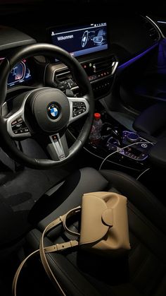 the interior of a bmw car with its dashboard and steering wheel, including an electronic display