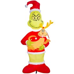 an inflatable grin face holding a baby wearing a santa hat and standing upright