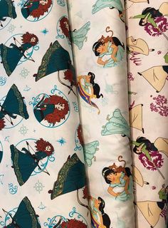 several different disney princesses on white fabric