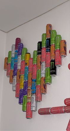 a heart made out of cans hanging on the wall