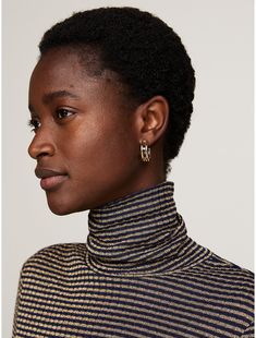 Tommy Hilfiger women's top. This party-ready turtleneck sweater was made for day-to-evening wear, thanks to its streamlined slim fit and sparkling metallic stripe design.  Material: 76% Viscose, 12% Metallic, 12% Polyamide. Elegant Striped Winter Tops, Tommy Hilfiger Women, Stripes Design, Evening Wear, Turtleneck Sweater, Tommy Hilfiger, Turtle Neck, Slim Fit, Women's Top