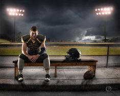 a football player is sitting on a bench in front of the field with his helmet