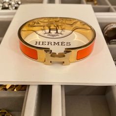 Hermes Clic H Bracelet - Orange Fruit / Gold Gorgeous Hermes Classic Clic H Bracelet. A Must Have For Every Fashionista! Narrow Bracelet In Enamel With Gold-Plated Hardware. In Their Staple Orange Color. Brand New. Never Been Used. But. No Box Included. Comes Fully Sanitized From A Smoke Free Home. Vintage Hermes Jewelry, Orange Bracelet For Formal Occasions, Formal Orange Bracelet Jewelry, Formal Orange Bracelet, Modern Orange Bangle Bracelets, Elegant Orange Bangle Jewelry, Elegant Orange Bracelet For Gift, Hermes Clic H Bracelet, Bracelet Hermes