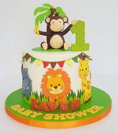 a birthday cake with a monkey and giraffe on top