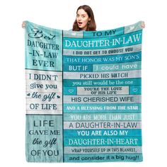 a woman holding up a blanket that says daughter - in - law and i didn't give you the gift of life