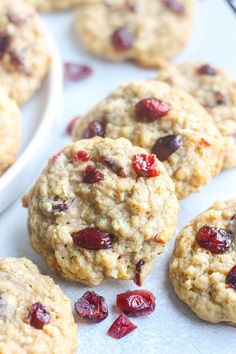 cranberry oatmeal cookies are on a baking sheet and ready to be eaten