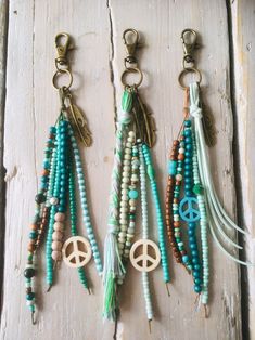 three key chains with peace signs and beads