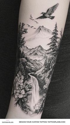 a black and white photo of a bird flying over a waterfall with mountains in the background