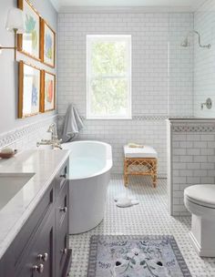 a bathroom with a tub, toilet and sink