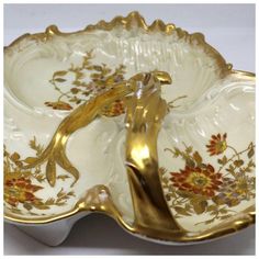 an ornately decorated dish with gold trimming