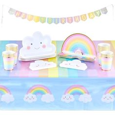 a rainbow themed birthday party set up with paper plates, cups and napkins