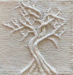 a knitted tree is shown on the side of a piece of white fabric, which has been stitched together