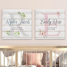 two baby nursery signs hanging on the wall next to a crib