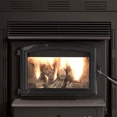 a person is using a vacuum to clean the fireplace's firewood and logs