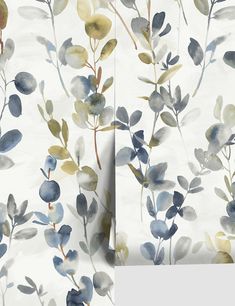 the wall paper has blue and yellow leaves on it