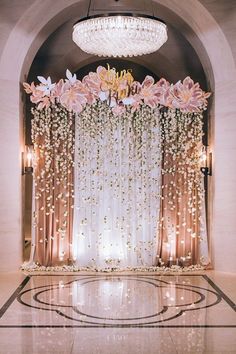 an elegant wedding setup with flowers and chandelier