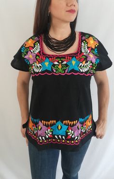 Be a trend with these beautiful mexican blouse made by hand in Chiapas, Mexico creating fashion and art. This is a beautiful blouse with colorful flowers and short sleeve. Very comfortable, Goes great with jeans, leggings, skirt, shorts... Each piece is unique and handmade with dedication and taking care of every detail achieving the best quality in our products, which is why it makes it beautiful and unique each of the embroidered flowers. Colors and flowers may vary depending on the size shown Festival Blouse With Embroidered Neckline And Short Sleeves, Fitted Top With Short Sleeves For Fiesta, Fitted Short Sleeve Blouse For Fiesta, Festival Short Sleeve Blouse With Geometric Embroidery, Multicolor Embroidered Neckline Short Sleeve Blouse, Short Sleeve Blouse With Geometric Embroidery For Festival, Multicolor Embroidered Neckline Blouse With Short Sleeves, Fitted Short Sleeve Tops For Fiesta, Multicolor Embroidered Short Sleeve Blouse