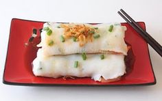 two fish fillets on a red plate with chopsticks