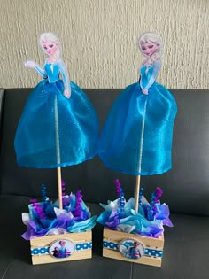 two frozen princess figurines sitting on top of each other