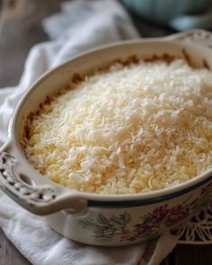 a casserole dish with shredded cheese in it