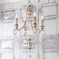 an old chandelier with candles hanging from it