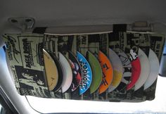 a row of surfboards hanging from the back of a car's front seat