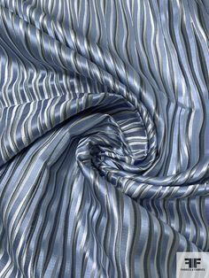 an image of a blue and white striped fabric that is very soft to see on the surface